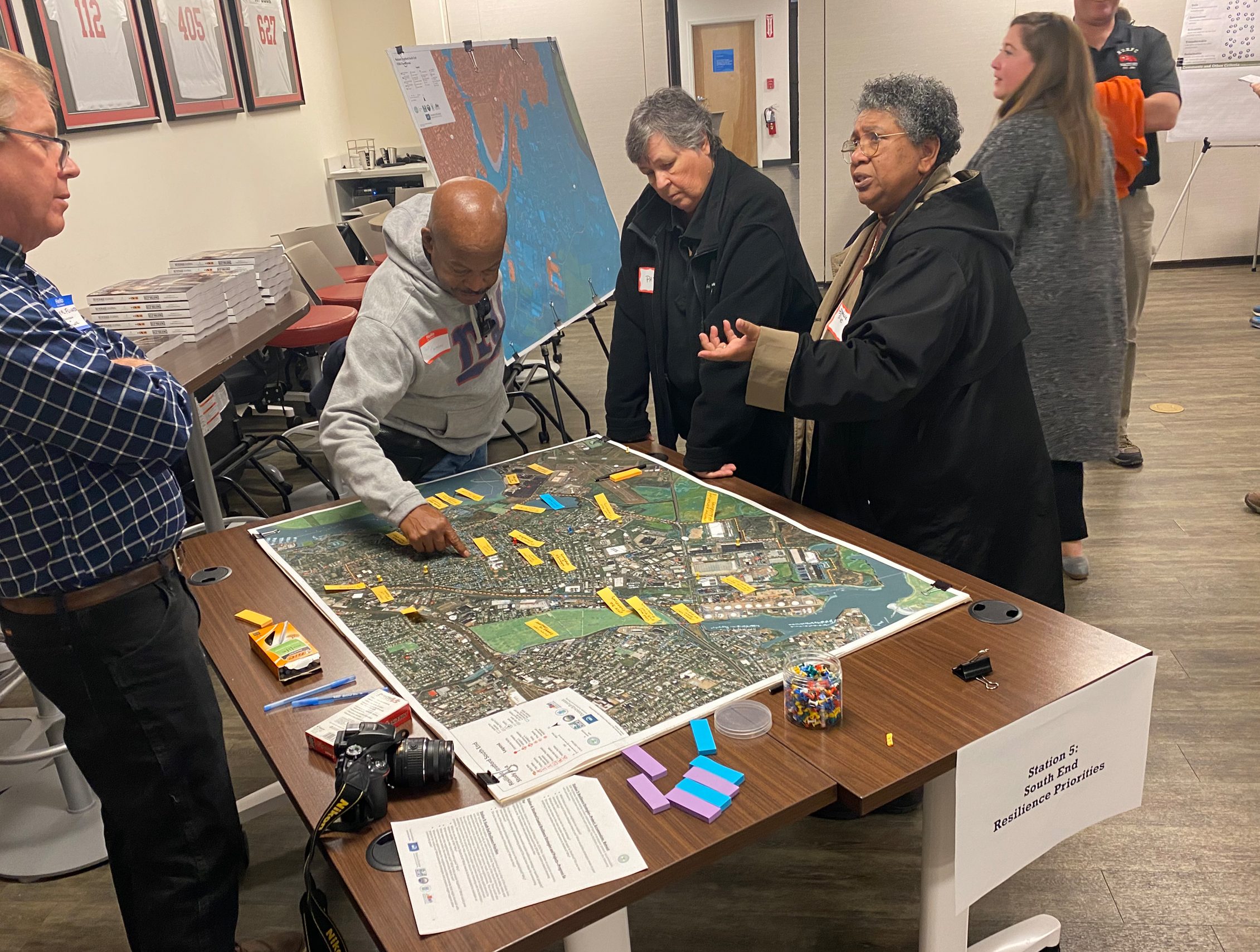 people gathered around a map of a city